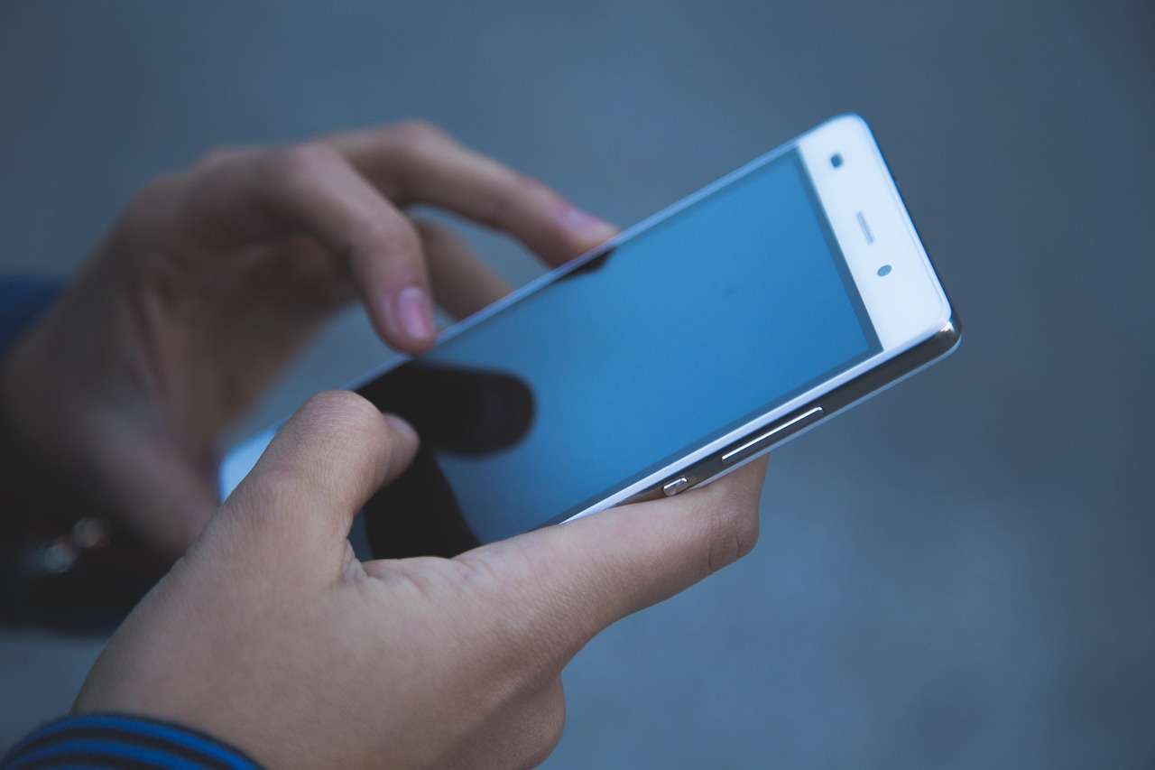 Voyageur utilisant une application de voyage sur son smartphone